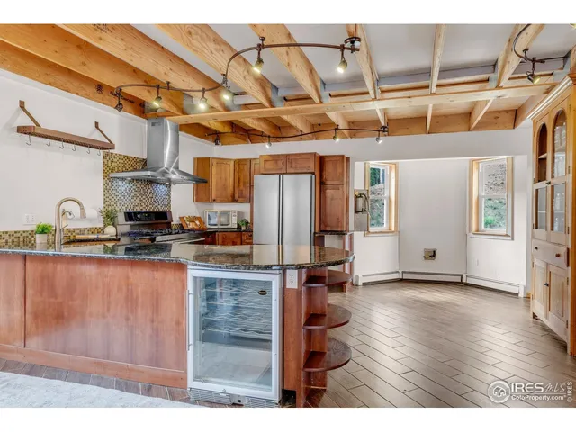 a kitchen with stainless steel appliances granite countertop a refrigerator and a sink