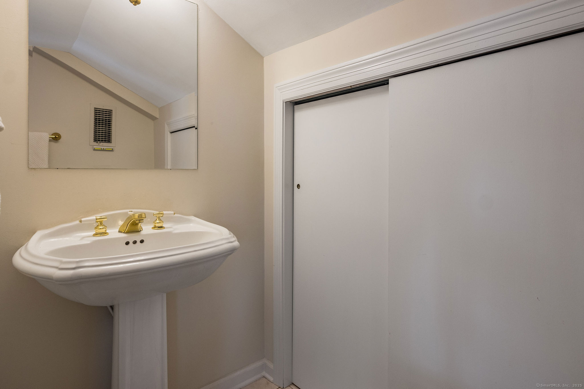 153 Shore Road, Unit 2 Clinton, CT 06413 - Photo 14 of 14 a bathroom with a sink a mirror and a toilet