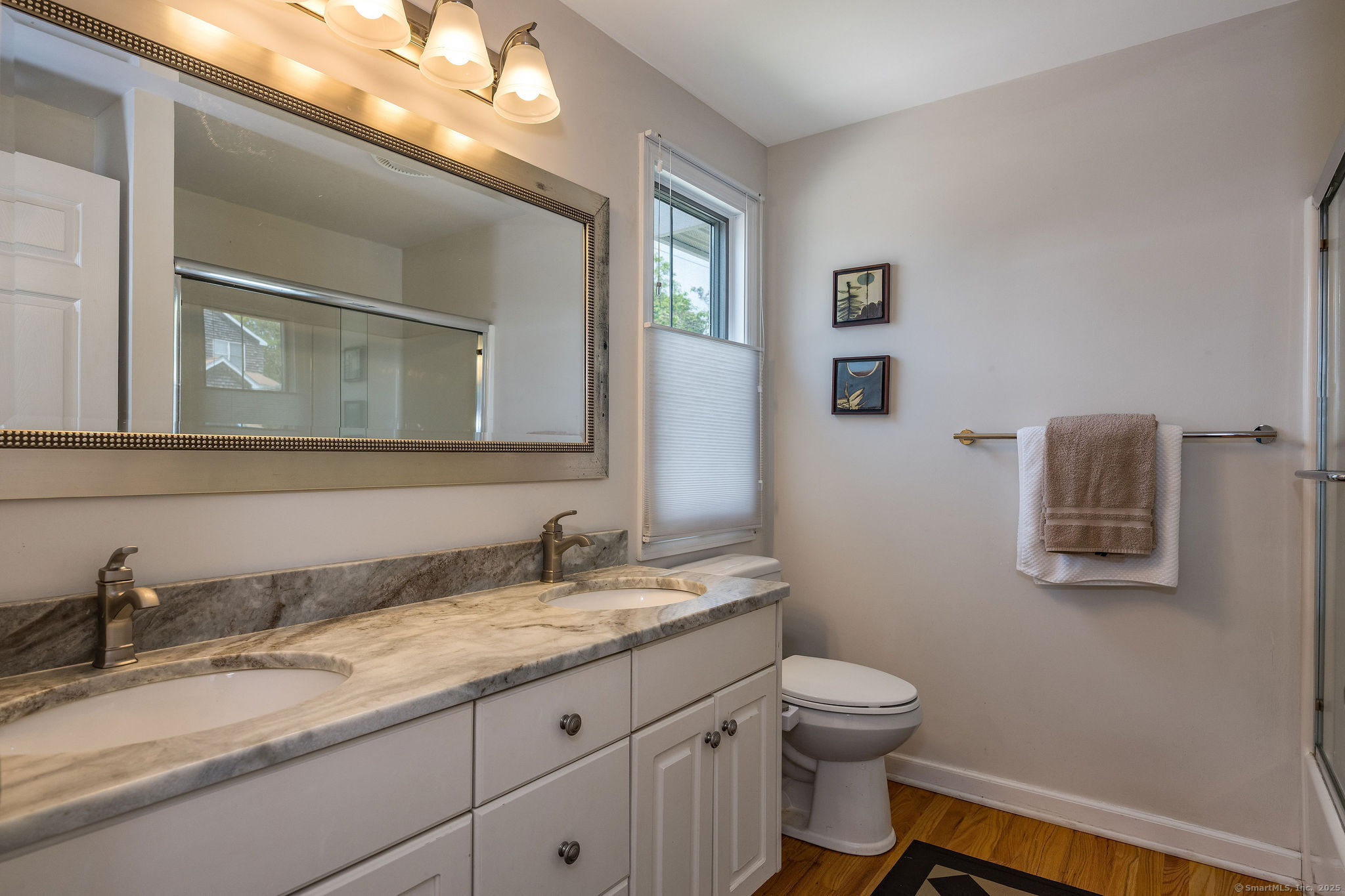 153 Shore Road, Unit 2 Clinton, CT 06413 - Photo 10 of 14 a bathroom with a granite countertop toilet sink and mirror