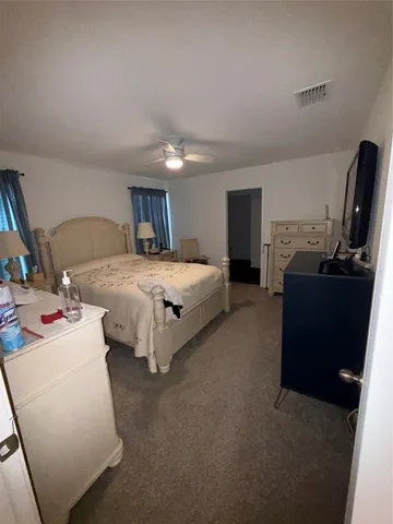 a bedroom with bed and window