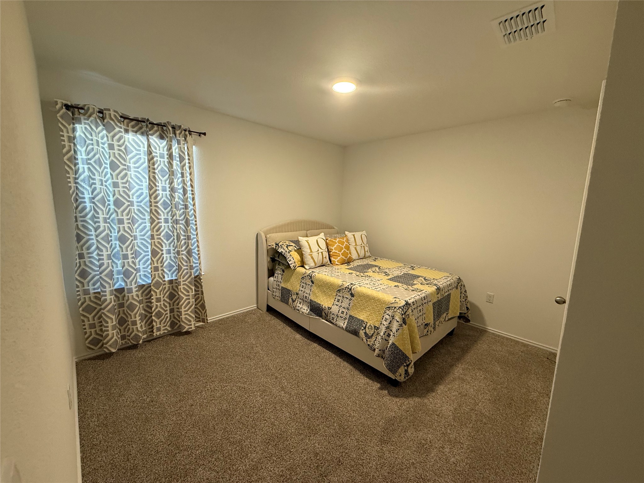 14812 Perlino Way Manor, Unit B Austin, TX 78721 - Photo 9 of 11 Carpeted bedroom with baseboards