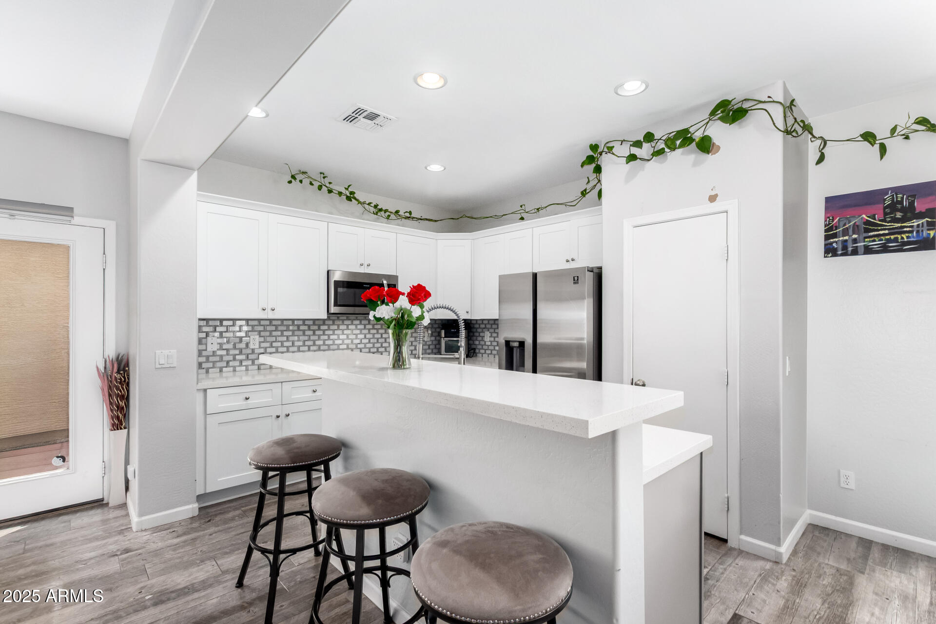 a kitchen with granite countertop a refrigerator and a stove top oven
