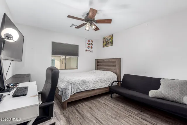 a bedroom with a bed and a flat screen tv