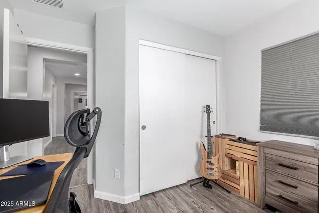 a view of a workspace with furniture and gym equipment