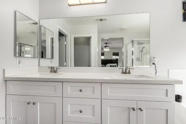 a bathroom with a sink vanity and mirror