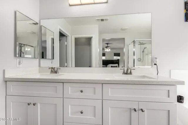 a bathroom with a sink vanity and mirror