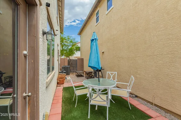 a view of balcony with chairs and a potted plant