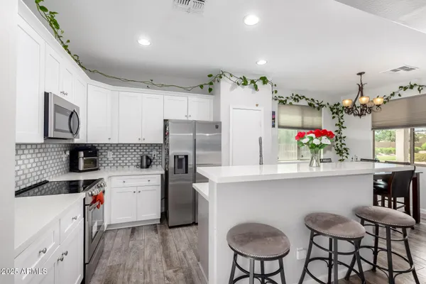 a kitchen that has a refrigerator and wooden cabinets