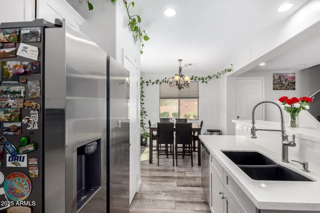 a kitchen with refrigerator and cabinets