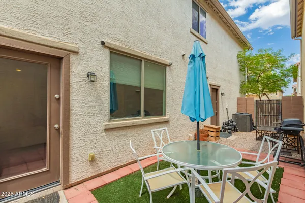 a table and chairs in front of a house