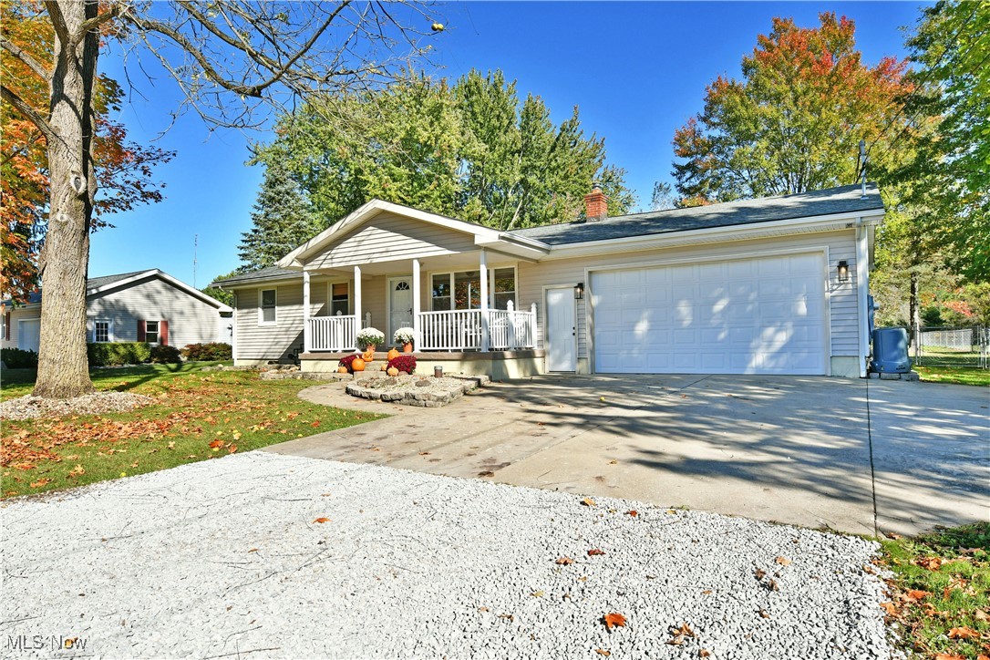 4400 Ridge Road Cortland, OH 44410 - Photo 48 of 50 Ranch-style home featuring covered porch, concrete driveway, a chimney, and an attached garage