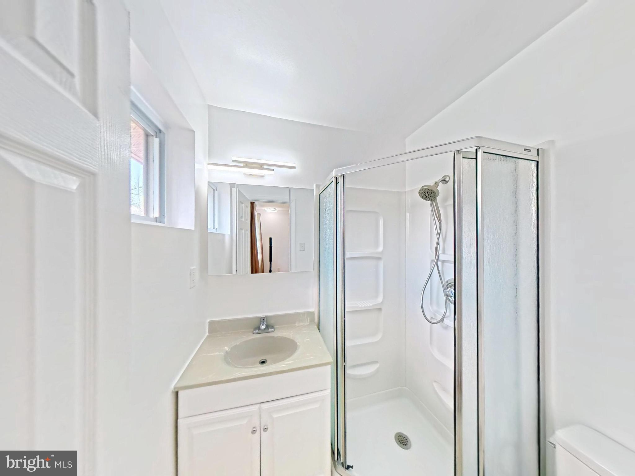 1012 Loxford Terrace Silver Spring, MD 20901 - Photo 11 of 52 a bathroom with a shower a sink and a mirror