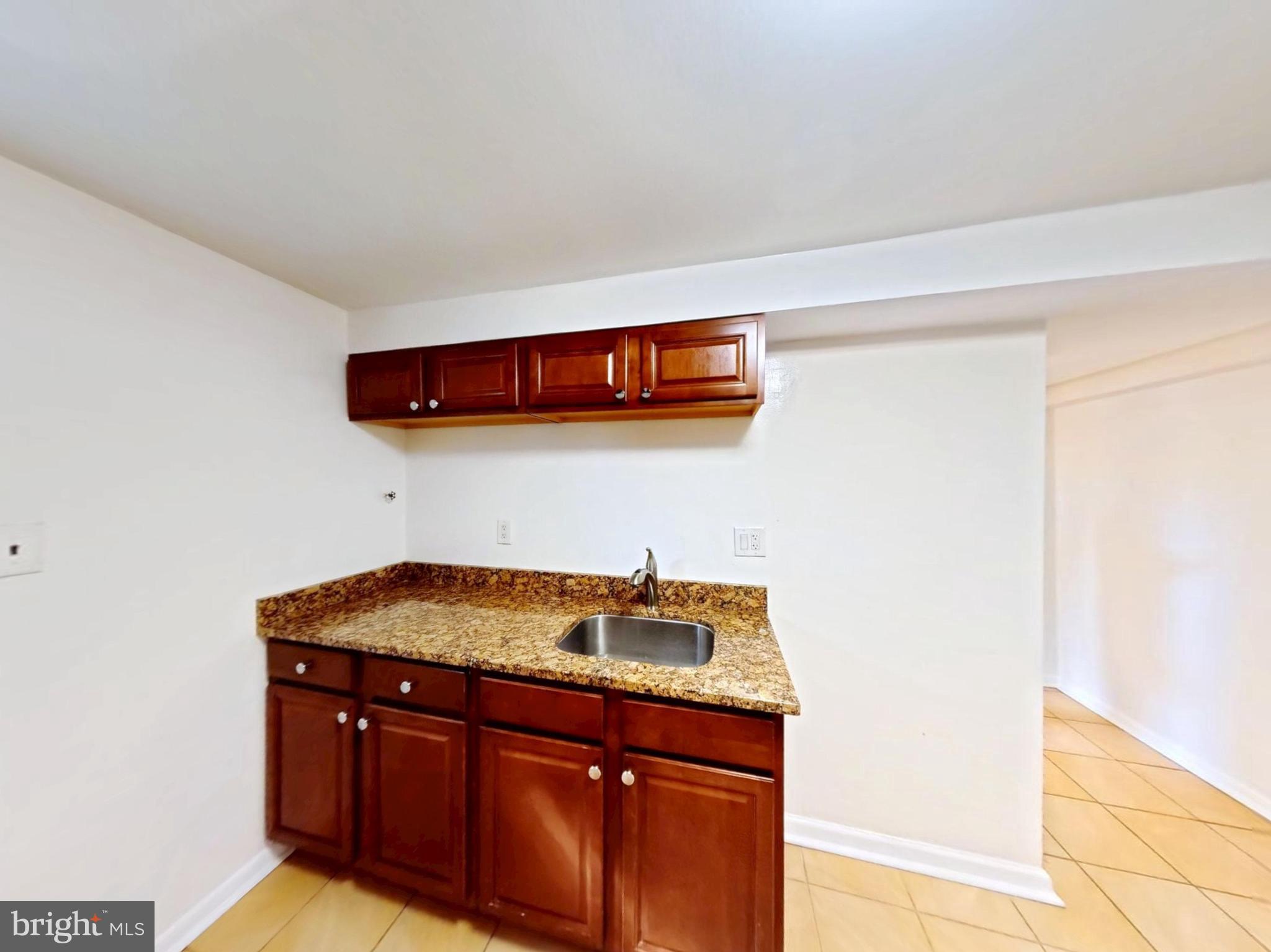 1012 Loxford Terrace Silver Spring, MD 20901 - Photo 16 of 52 a kitchen with a sink and cabinets