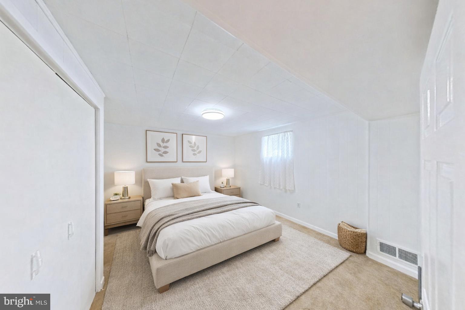 1012 Loxford Terrace Silver Spring, MD 20901 - Photo 20 of 52 a bedroom with a bed and a lamp