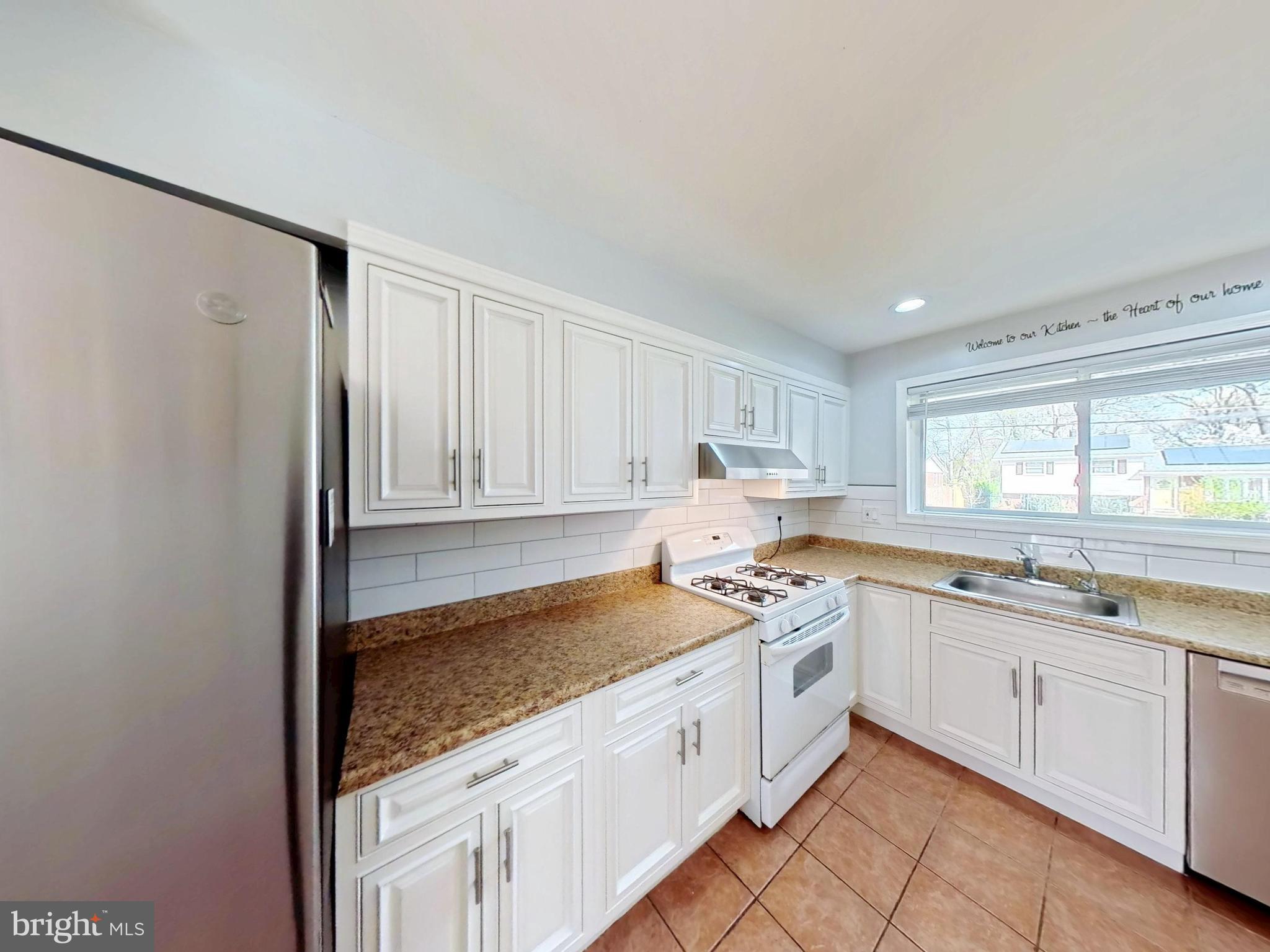 1012 Loxford Terrace Silver Spring, MD 20901 - Photo 24 of 52 a kitchen with a sink stove and cabinets