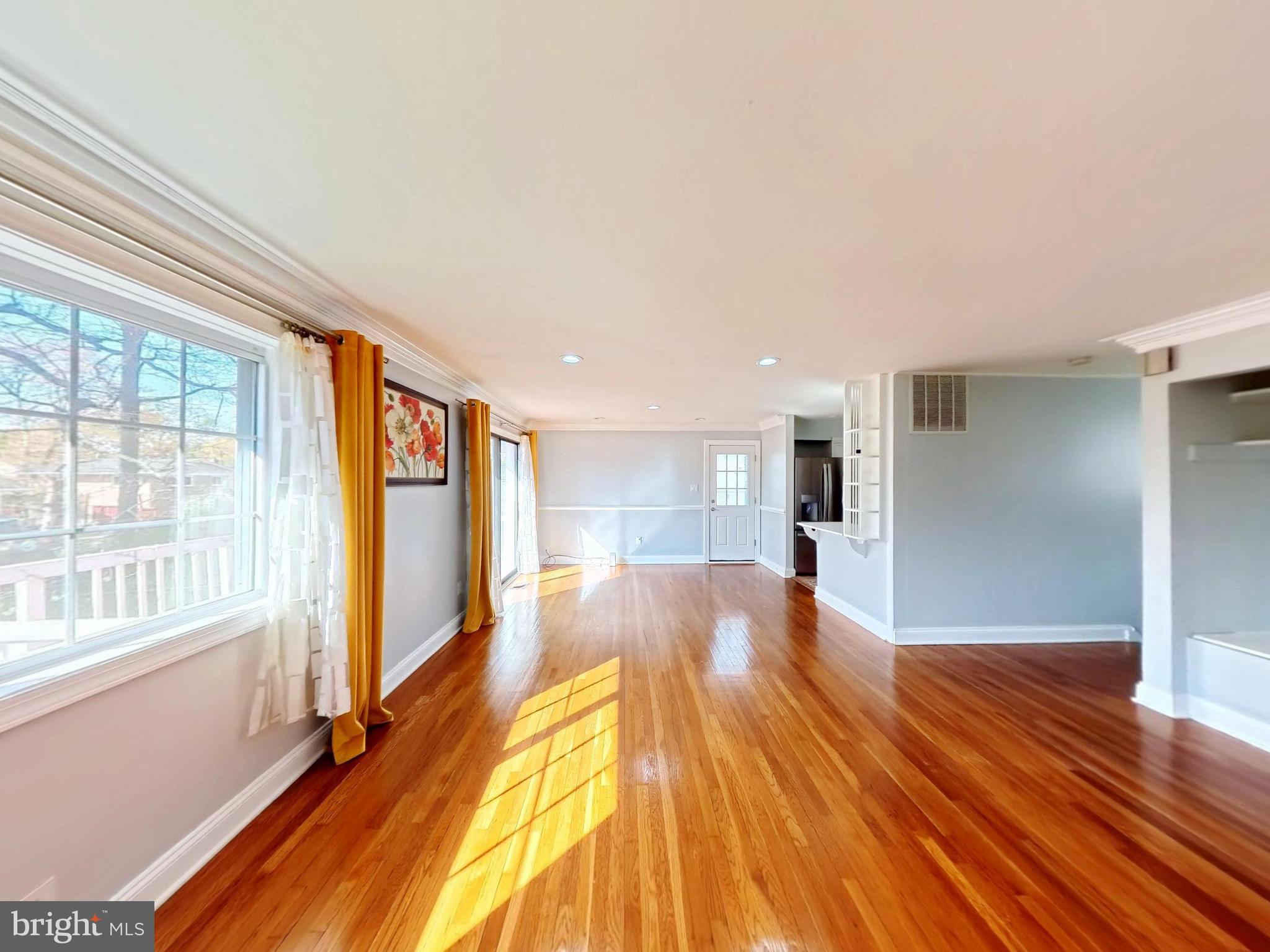 1012 Loxford Terrace Silver Spring, MD 20901 - Photo 26 of 52 a view of a big room with wooden floor and windows