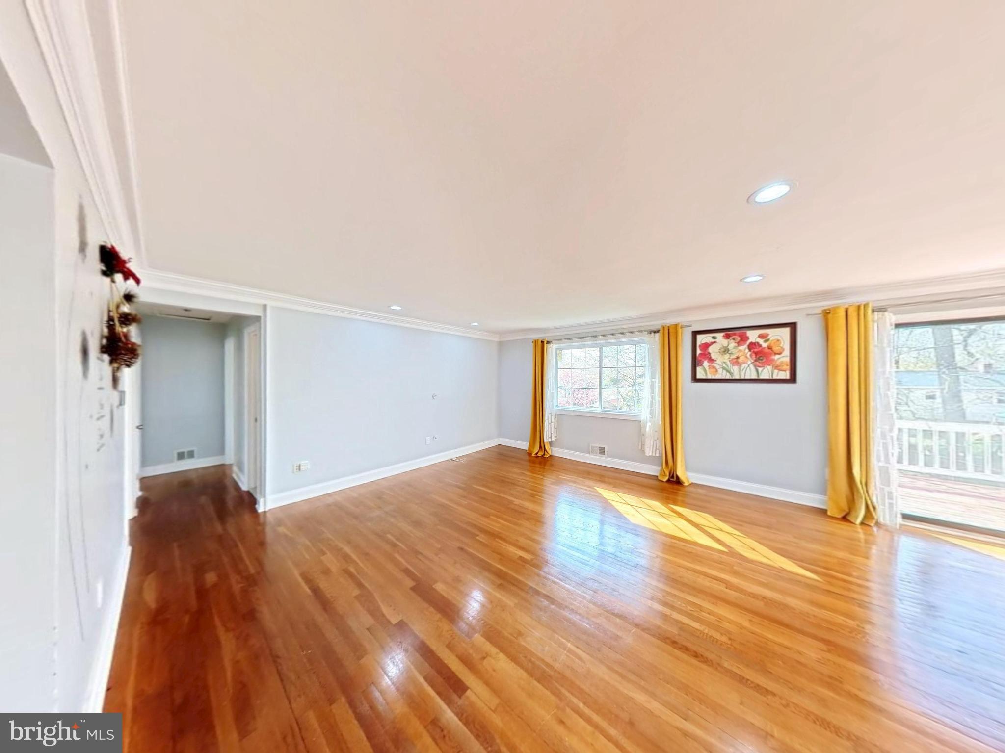 1012 Loxford Terrace Silver Spring, MD 20901 - Photo 28 of 52 a view of an empty room with wooden floor and a window