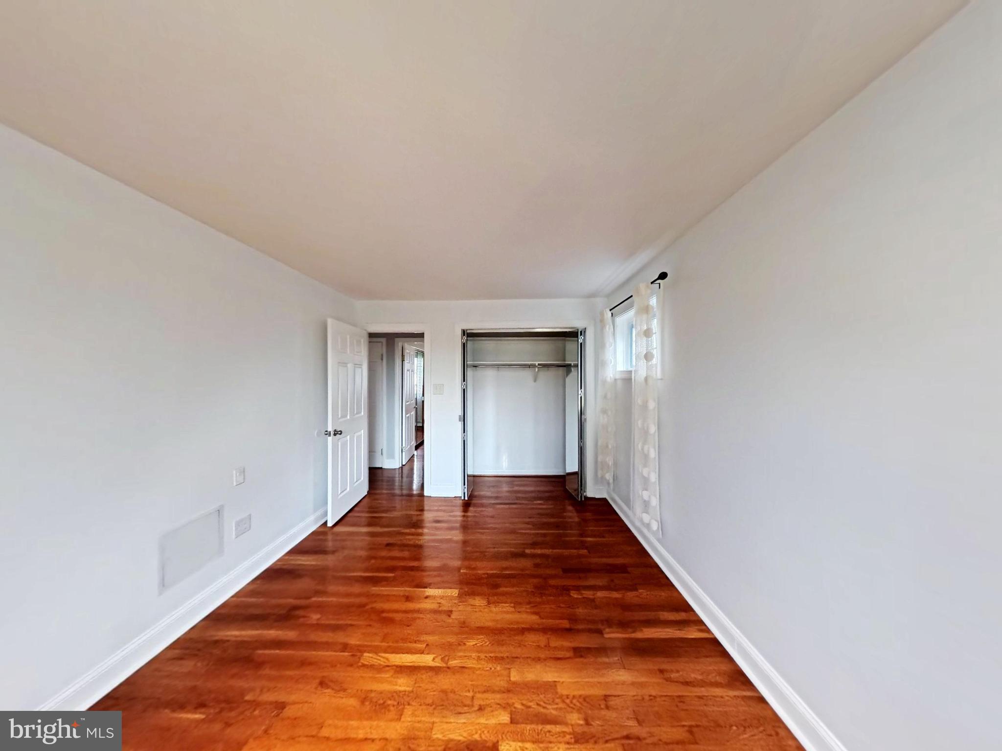 1012 Loxford Terrace Silver Spring, MD 20901 - Photo 30 of 52 a view of an empty room with wooden floor