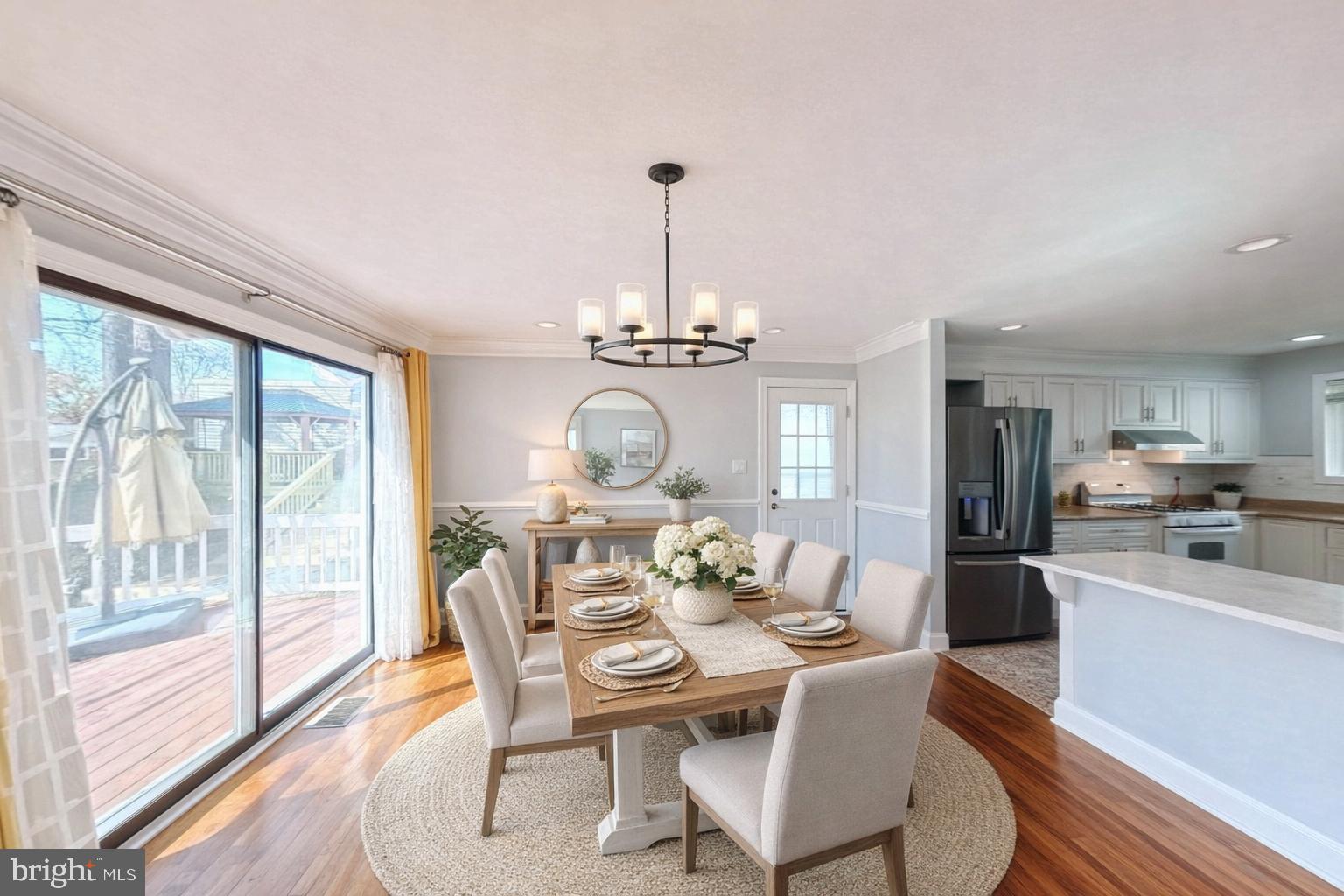 1012 Loxford Terrace Silver Spring, MD 20901 - Photo 3 of 52 a dining room with furniture a chandelier and wooden floor