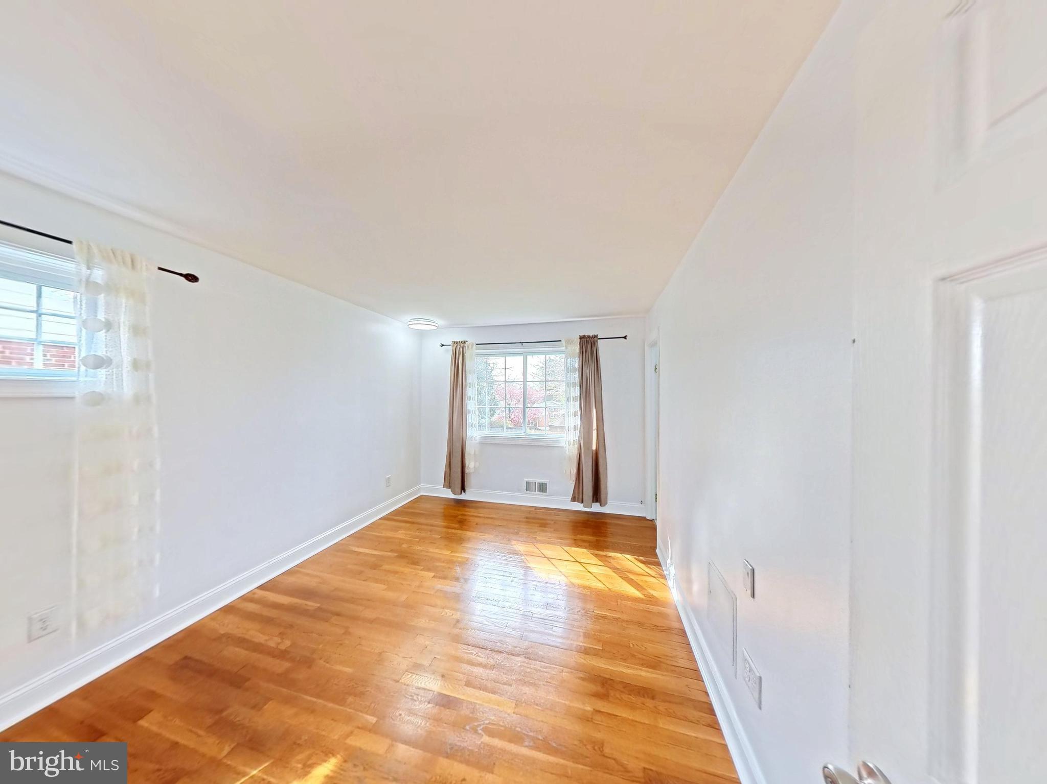 1012 Loxford Terrace Silver Spring, MD 20901 - Photo 40 of 52 a view of empty room with wooden floor and fan