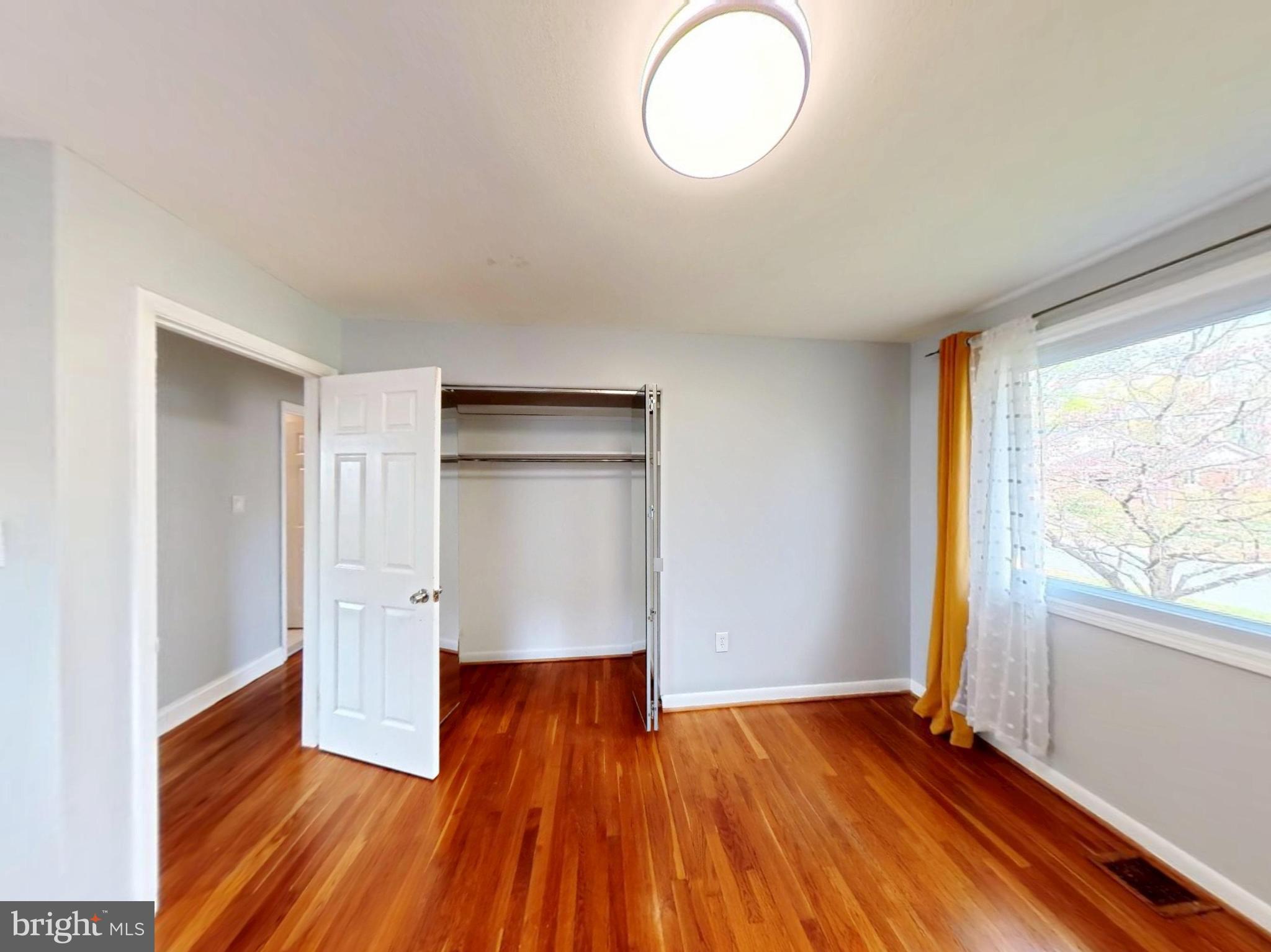 1012 Loxford Terrace Silver Spring, MD 20901 - Photo 42 of 52 a view of empty room with wooden floor and fan
