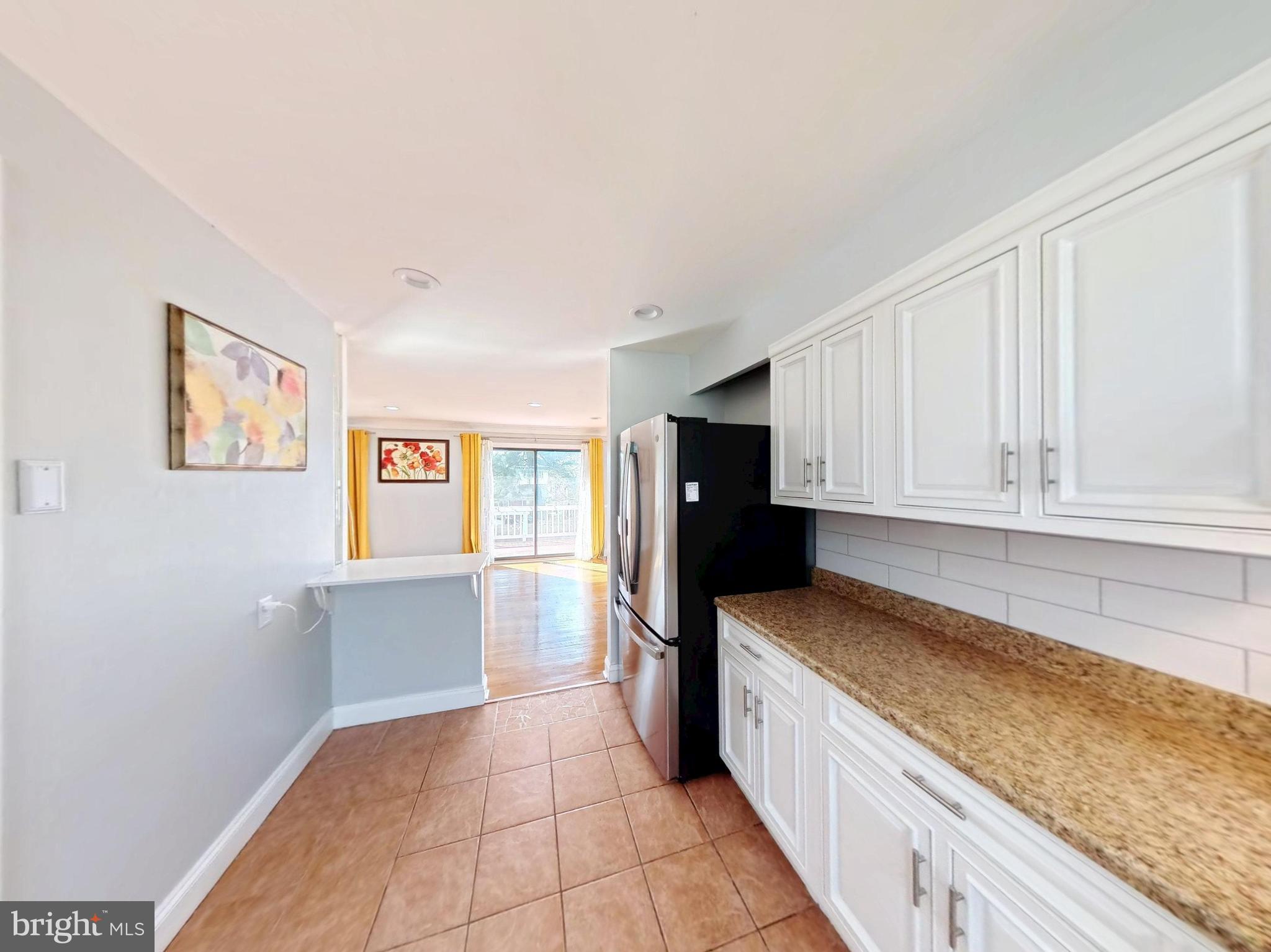1012 Loxford Terrace Silver Spring, MD 20901 - Photo 6 of 52 a kitchen with stainless steel appliances granite countertop a refrigerator and a stove top oven