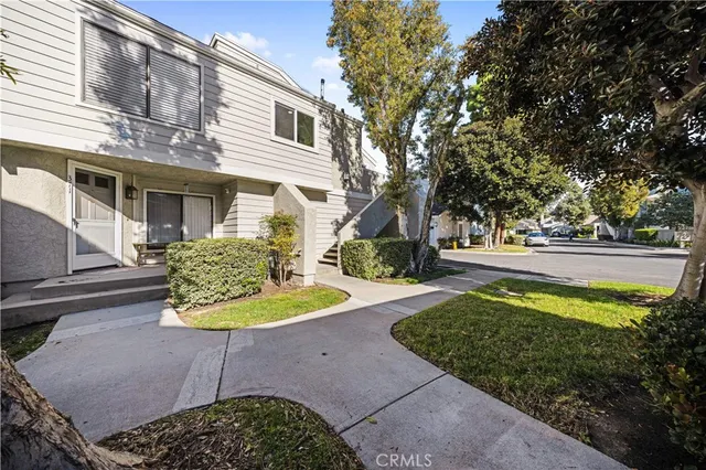 a living room with furniture a fireplace and a chandelier