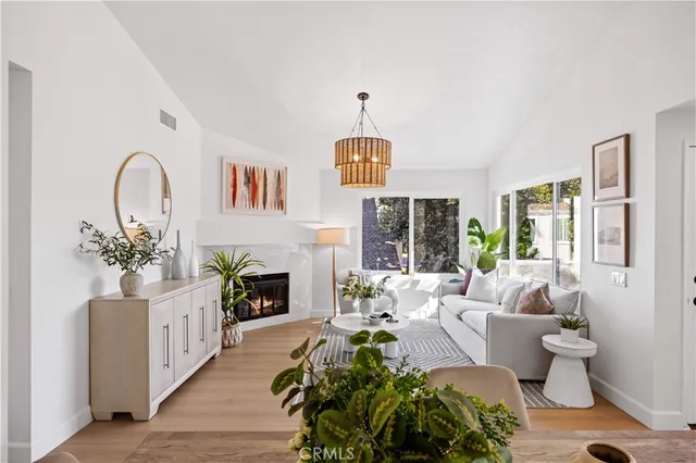 a kitchen with granite countertop a sink a stove and wooden floors