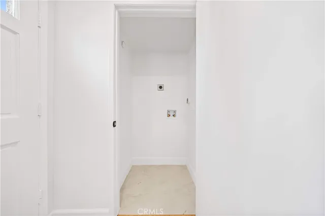 a kitchen with stainless steel appliances a stove a sink and white cabinets