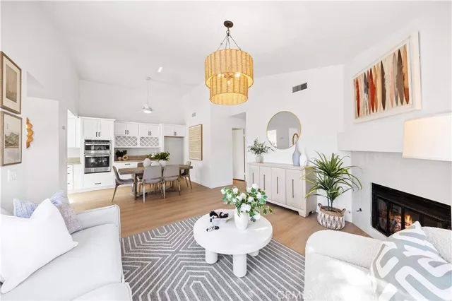 a living room with furniture a chandelier and a table