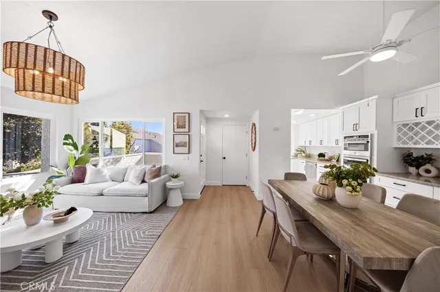 a living room with furniture a fireplace and a chandelier