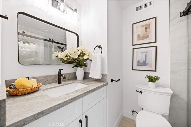 a balcony with stainless steel appliances table and chairs