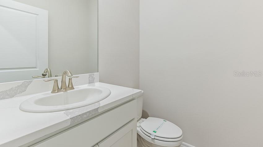 1925 Cobb Trail Parrish, FL 34219 - Photo 18 of 25 a bathroom with a sink a toilet and mirror