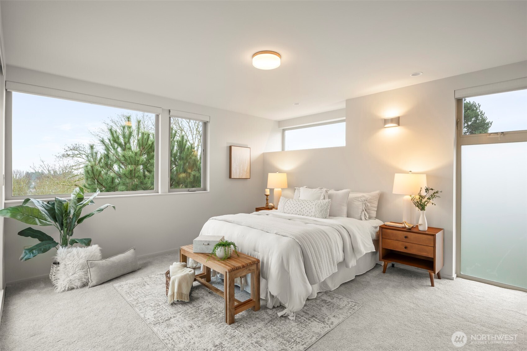 1810 23rd Avenue, Unit A Seattle, WA 98122 - Photo 4 of 26 a bedroom with a bed and large windows