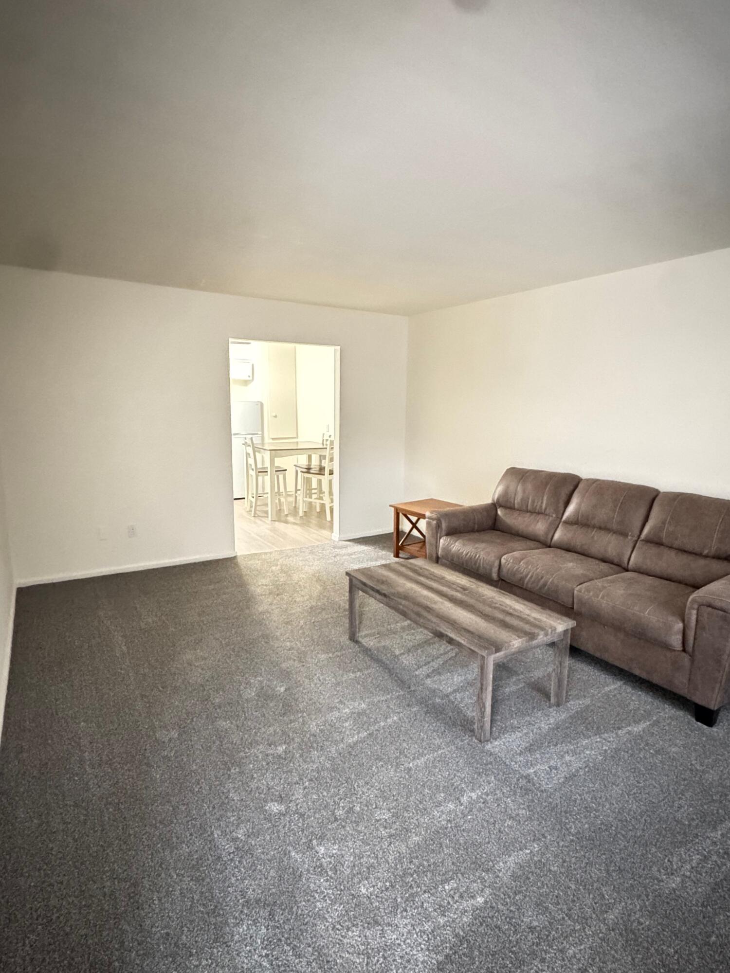 2619 19th Street, Unit 26 Lubbock, TX 79410 - Photo 3 of 5 a living room with furniture and a window