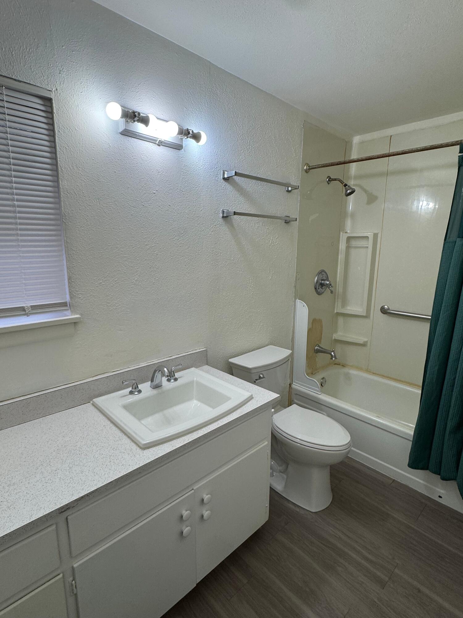 2619 19th Street, Unit 26 Lubbock, TX 79410 - Photo 4 of 5 a bathroom with a sink toilet a mirror and shower