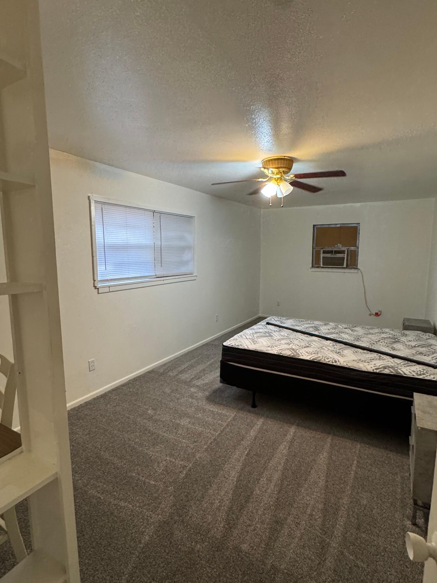 2619 19th Street, Unit 26 Lubbock, TX 79410 - Photo 5 of 5 a view of livingroom with furniture and chandelier fan