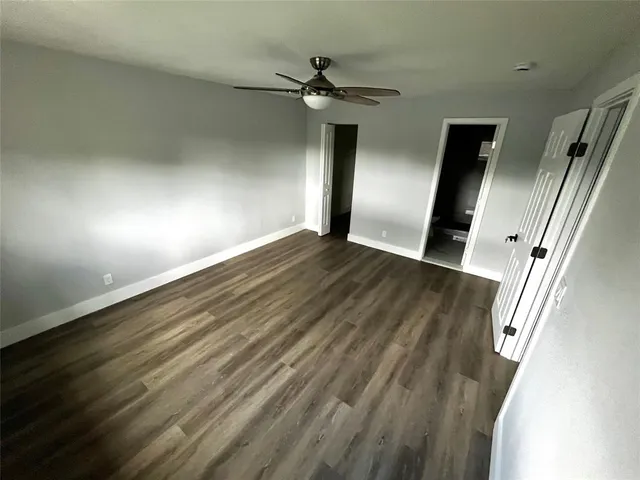 wooden floor in an empty room with a mirror