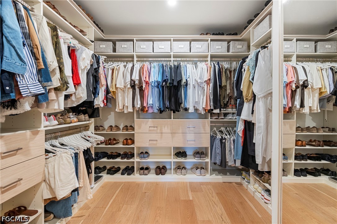 1115 Central Avenue, Unit 443 Naples, FL 34102 - Photo 33 of 40 a view of walk in closet with clothes and shoes