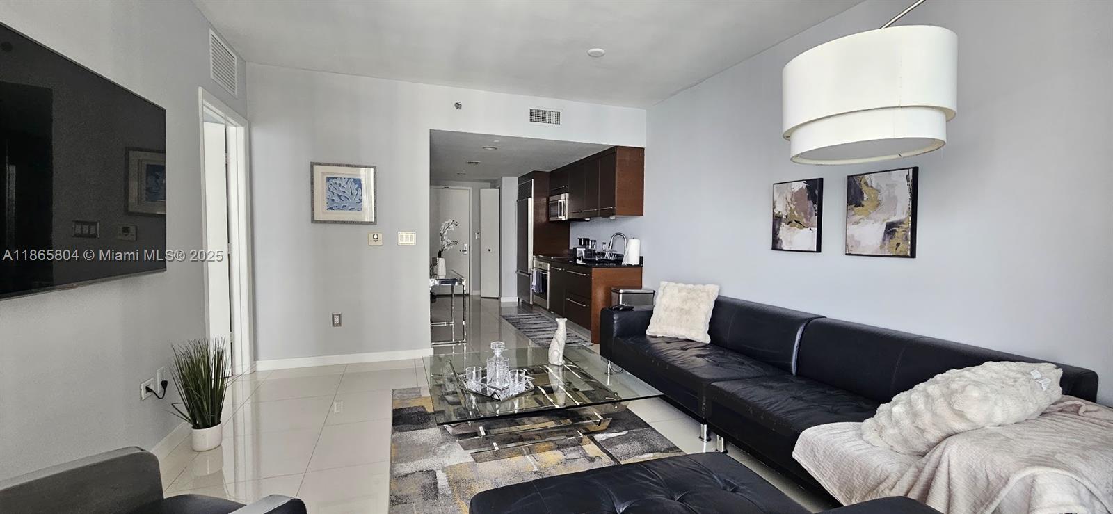 495 Brickell Avenue, Unit 3308 Miami, FL 33131 - Photo 4 of 15 a living room with furniture and a flat screen tv
