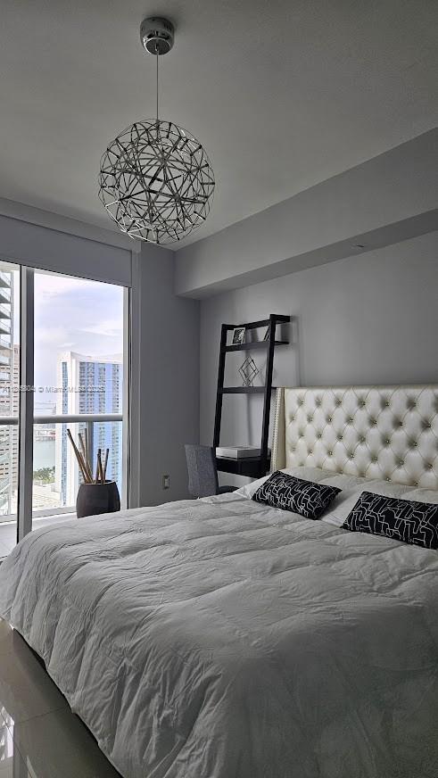 495 Brickell Avenue, Unit 3308 Miami, FL 33131 - Photo 6 of 15 a bedroom with a bed and a window