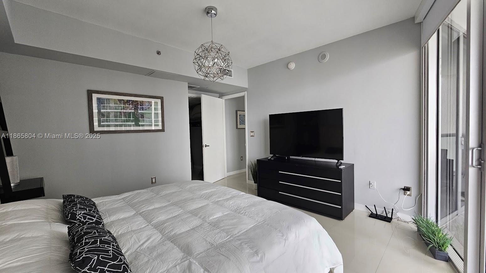 495 Brickell Avenue, Unit 3308 Miami, FL 33131 - Photo 7 of 15 a bedroom with a bed and a flat screen tv