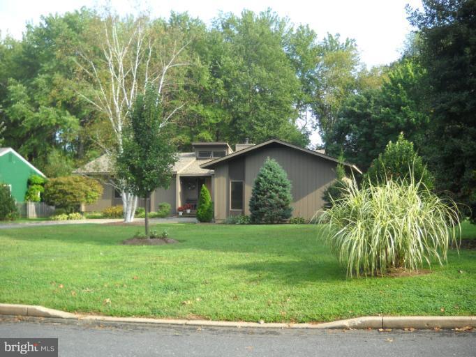 106 Birch Run Road Chestertown, MD 21620 - Photo 2 of 25 a backyard of a house with potted plants and large trees