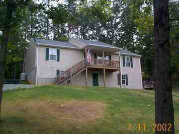208 Geranium Road Ruckersville, VA 22968 - Photo 1 of 4 a house that has a tree in front of the house