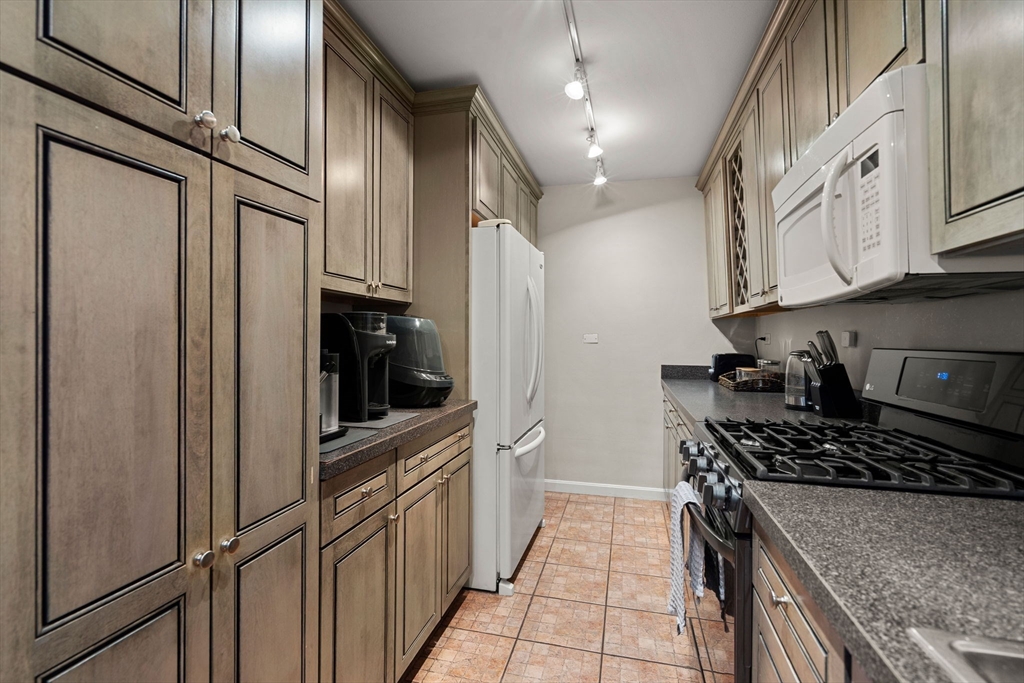 2 Hawthorne Place, Unit 17M Boston, MA 02114 - Photo 16 of 33 a kitchen with stainless steel appliances granite countertop a refrigerator and a stove