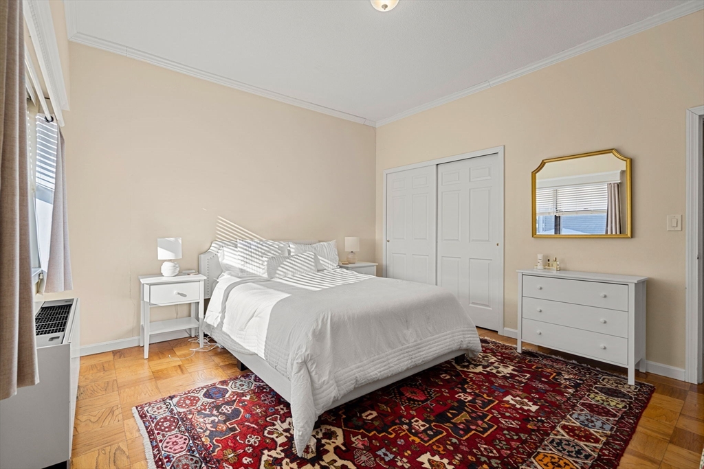 2 Hawthorne Place, Unit 17M Boston, MA 02114 - Photo 27 of 33 a bedroom with a bed and wooden floor