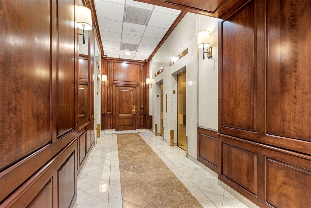 2 Hawthorne Place, Unit 17M Boston, MA 02114 - Photo 29 of 33 a view of a hallway with the wooden floor and door