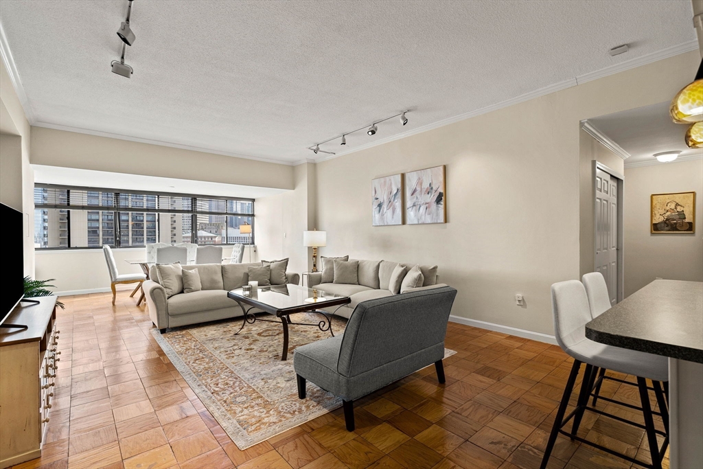 2 Hawthorne Place, Unit 17M Boston, MA 02114 - Photo 10 of 33 a living room with furniture and a table