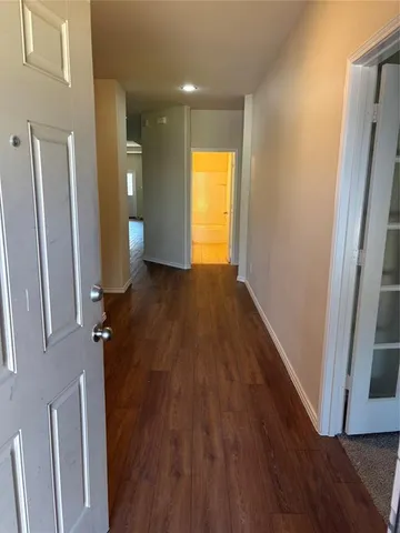 a view of hallway with wooden floor and stairs