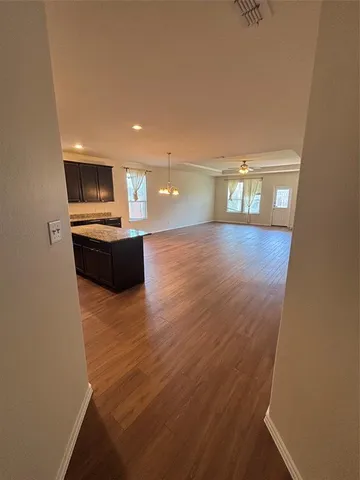 a view of a kitchen with wooden floor
